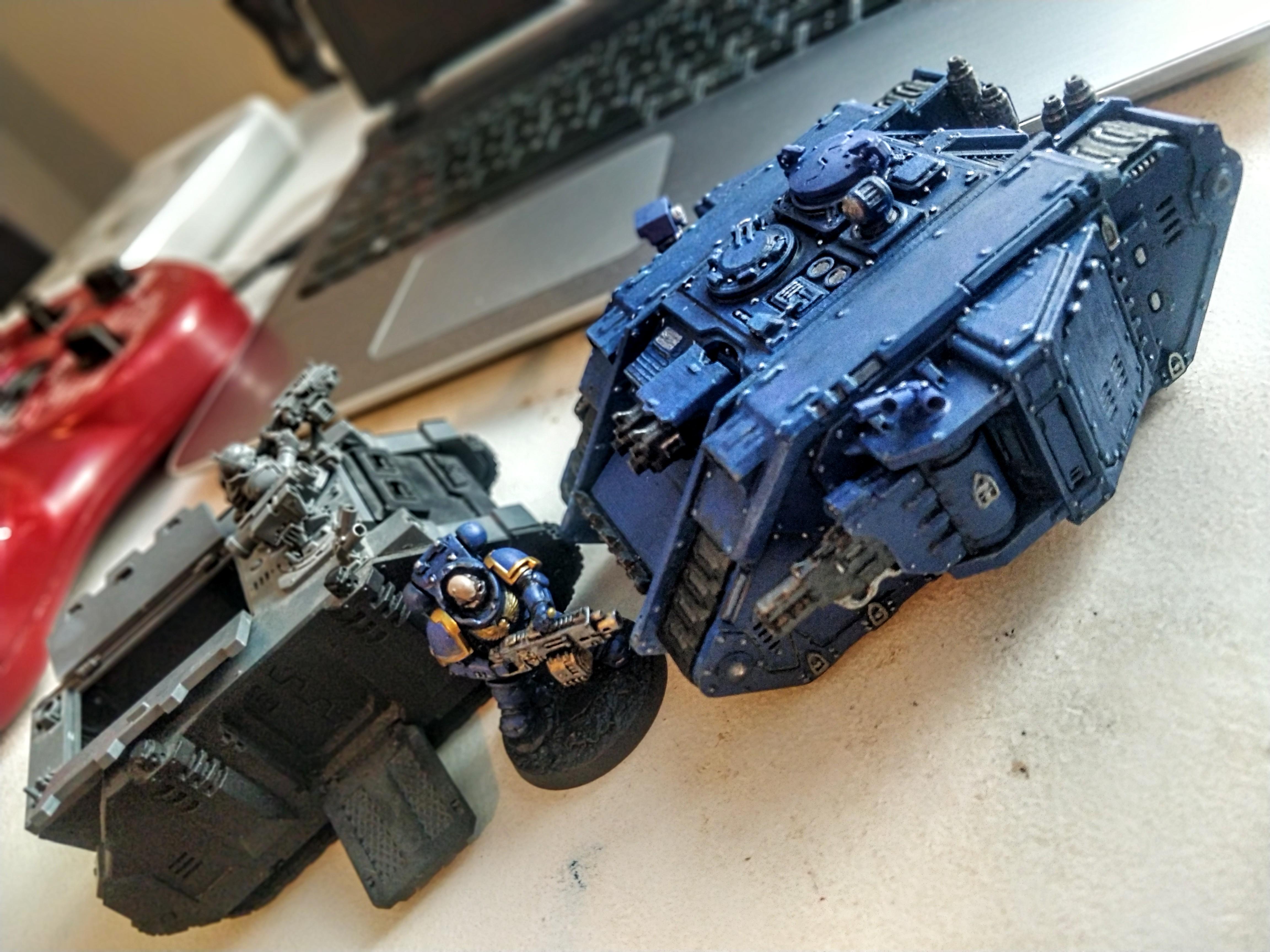 Third party 3D printed Land Raider next to genuine WH40 Rhino and